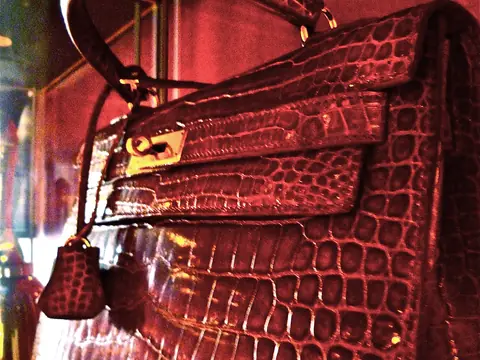A red crocodile Hermes Kelly bag with gold hardware and clochette
